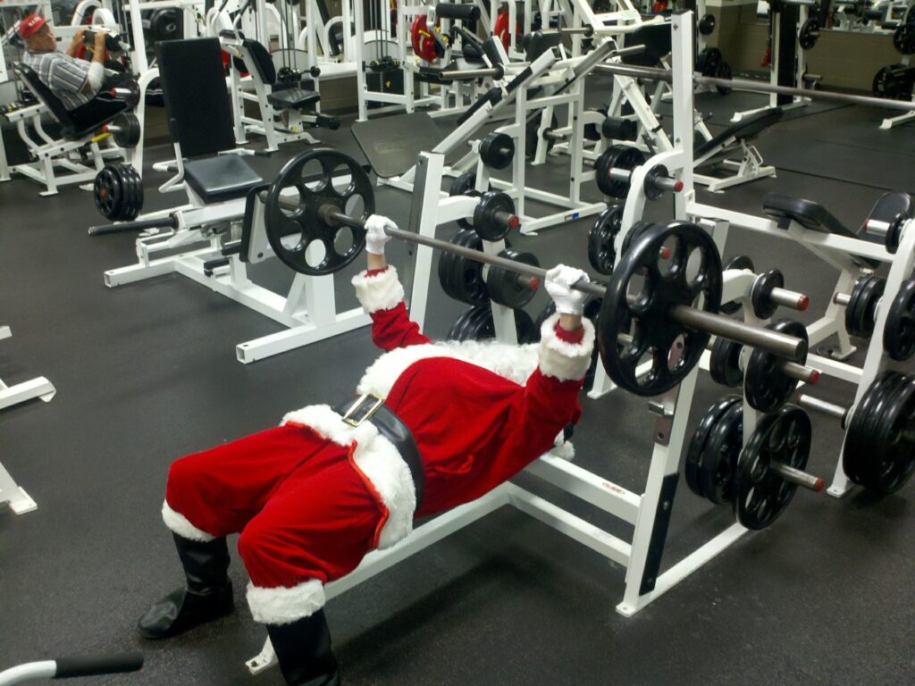 Santa in the gym doing chest presses