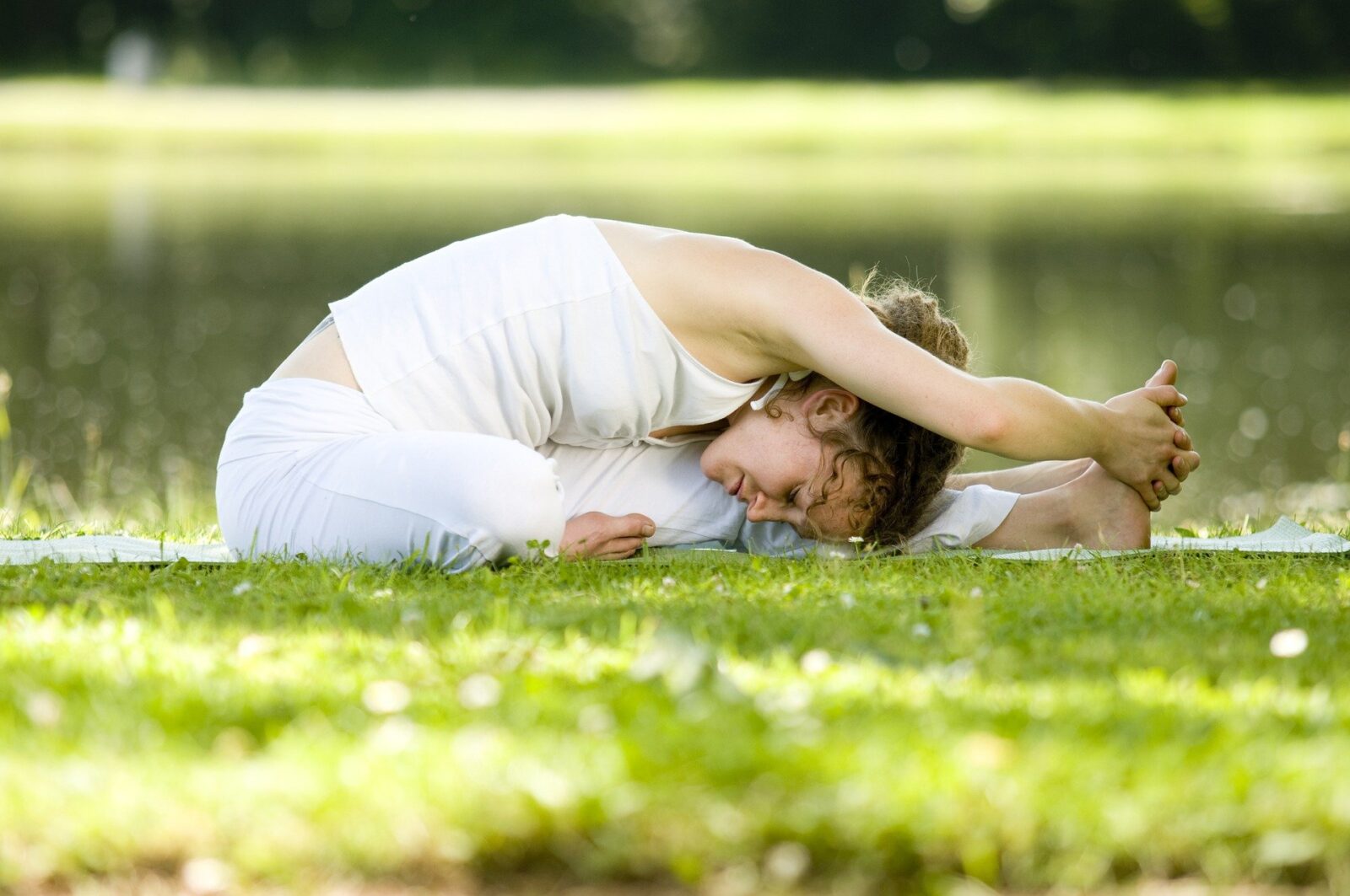 How to find time to exercise-lady doing yoga stretch on grass