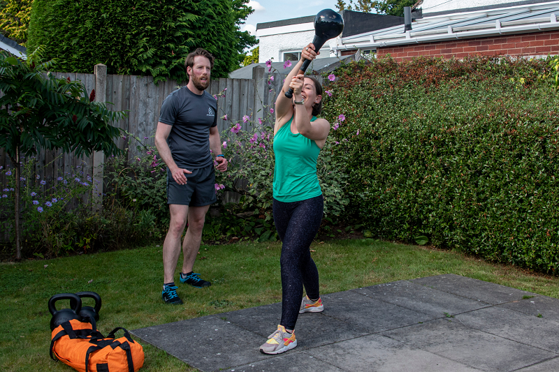 Rob shows his client woodchops in this outdoor workout